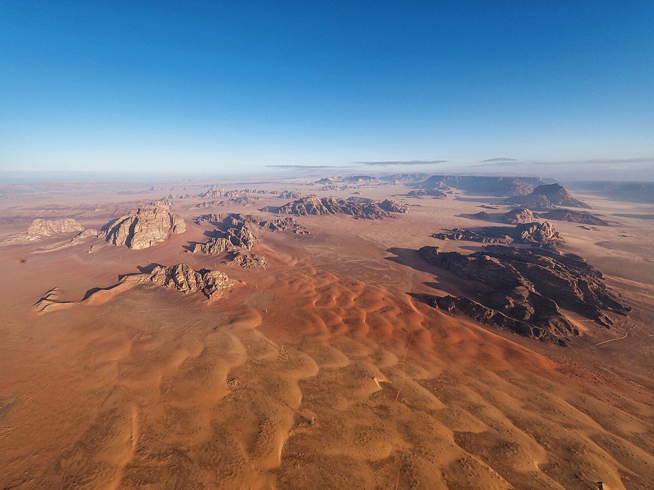 Aerial view over the dune fields and rock massifs of the Wadi Rum protected area
